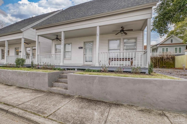 view of front of home featuring covered porch, ceiling fan, and roof with shingles