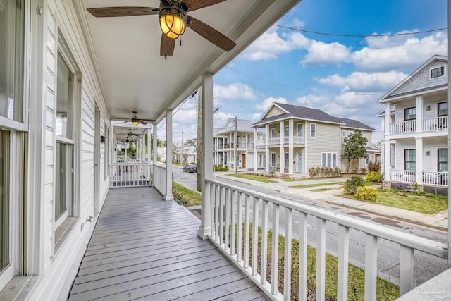 deck with ceiling fan and a residential view