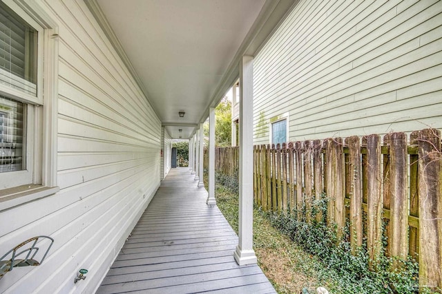 wooden terrace featuring fence