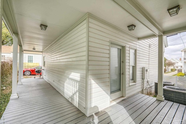 wooden terrace featuring central AC unit