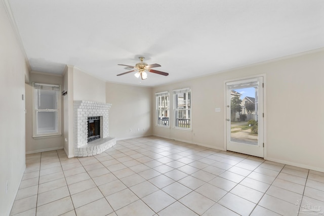 unfurnished living room featuring baseboards, ceiling fan, ornamental molding, a brick fireplace, and light tile patterned flooring