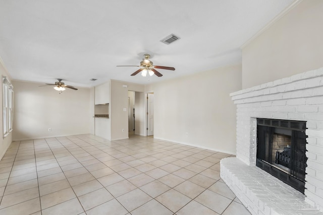 unfurnished living room featuring light tile patterned floors, a fireplace, a ceiling fan, baseboards, and crown molding