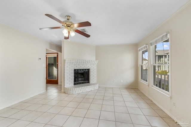 unfurnished living room featuring baseboards, visible vents, crown molding, a fireplace, and light tile patterned flooring