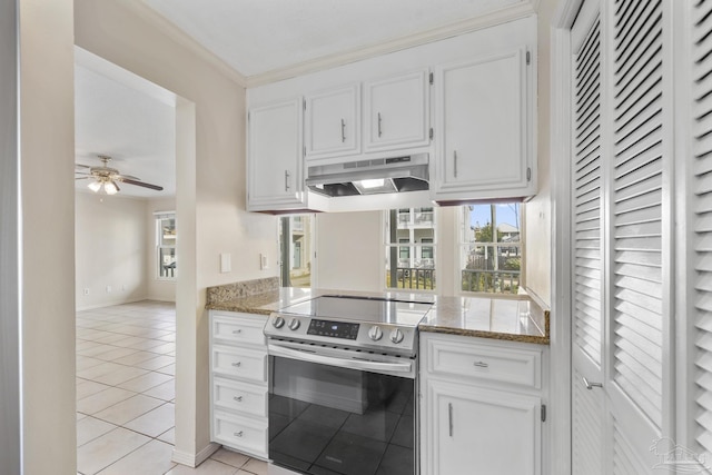 kitchen with under cabinet range hood, white cabinetry, electric range, and light tile patterned floors