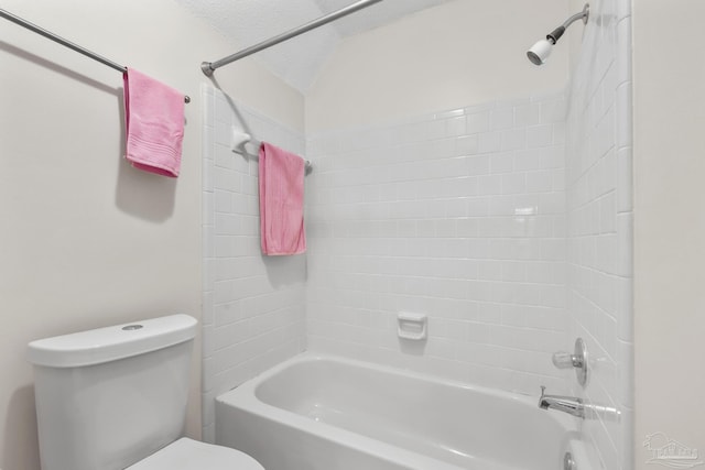 bathroom with a textured ceiling, tub / shower combination, and toilet