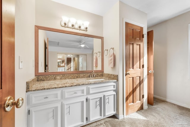 bathroom featuring a ceiling fan, vanity, and baseboards