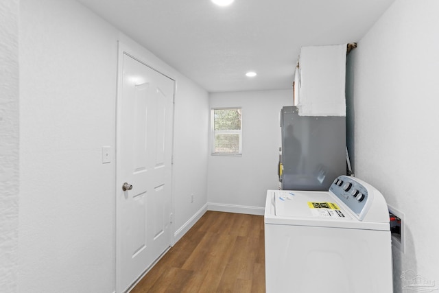 laundry room with recessed lighting, wood finished floors, washer and dryer, laundry area, and baseboards