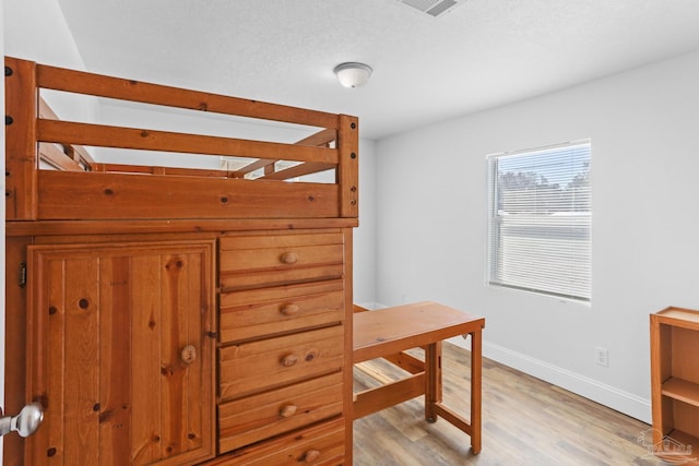 bedroom featuring light wood-type flooring and baseboards