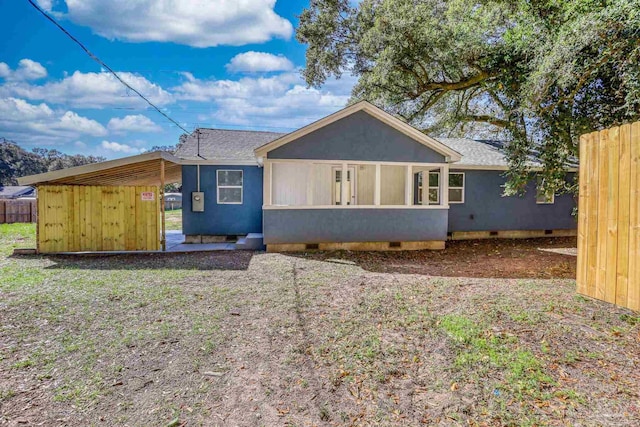 view of front of house with crawl space, a shingled roof, fence, and stucco siding