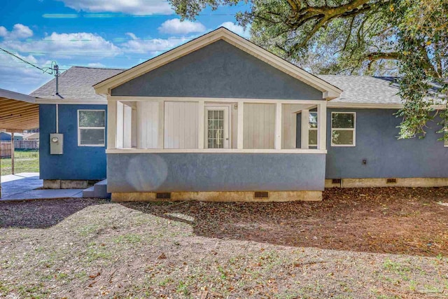 view of home's exterior featuring crawl space, stucco siding, and roof with shingles