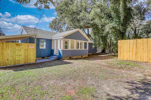 view of front of home with crawl space, a shingled roof, fence, and stucco siding