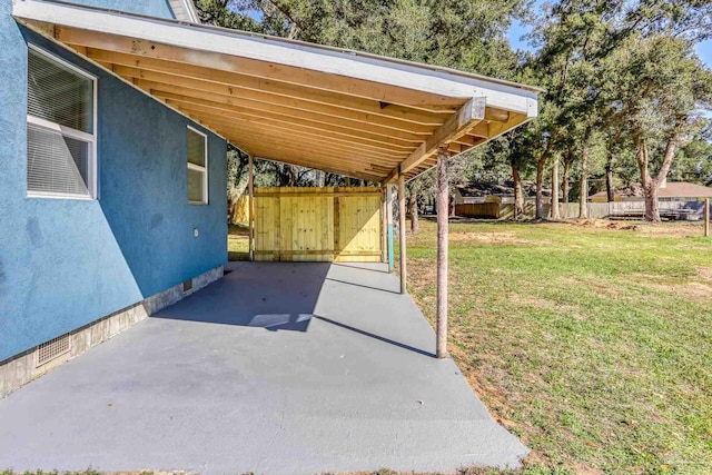 view of patio with a carport and fence