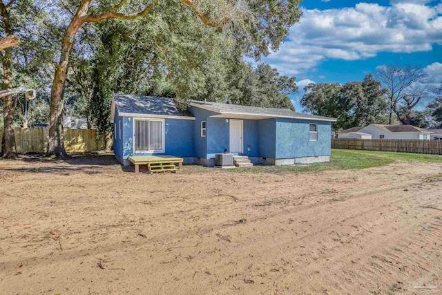 view of front of property featuring entry steps, crawl space, fence, and central AC