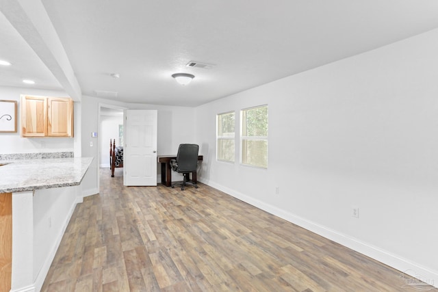 unfurnished office with baseboards, visible vents, wood finished floors, and recessed lighting