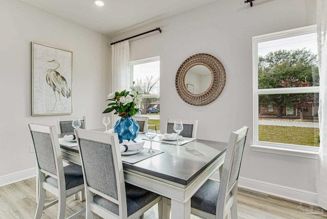 dining space with light hardwood / wood-style floors