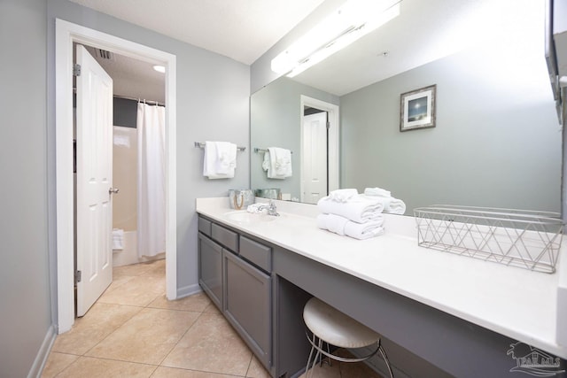 bathroom with curtained shower, tile patterned flooring, vanity, and baseboards