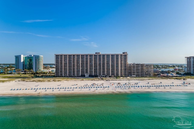 aerial view featuring a water view, a city view, and a view of the beach