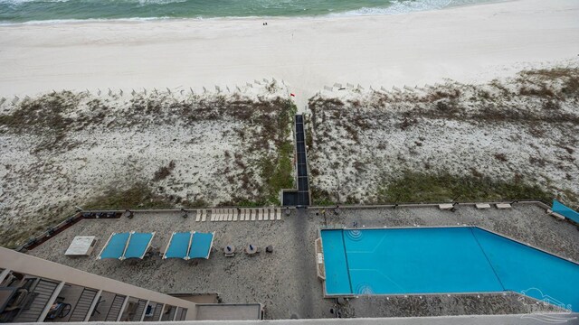 bird's eye view with a water view and a view of the beach