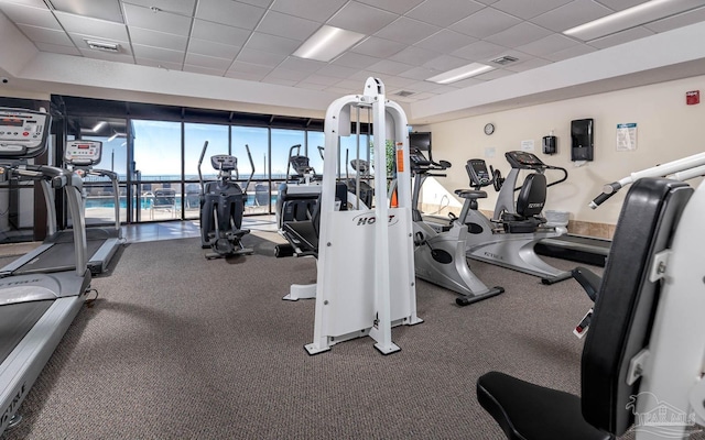 gym featuring a paneled ceiling and visible vents