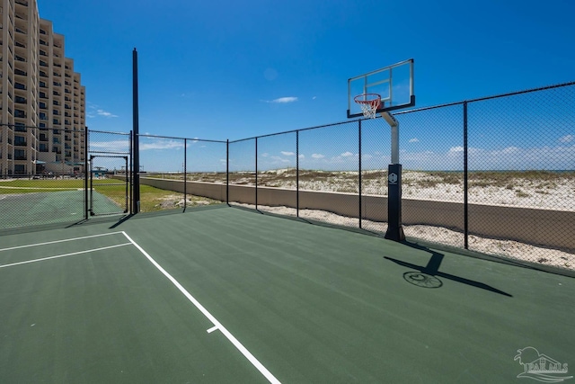 view of sport court featuring a gate, community basketball court, and fence