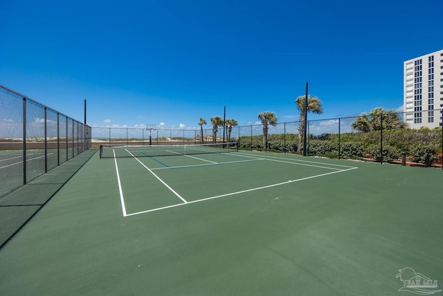 view of sport court featuring fence