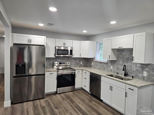 kitchen featuring sink, decorative backsplash, dark wood-type flooring, and stainless steel appliances