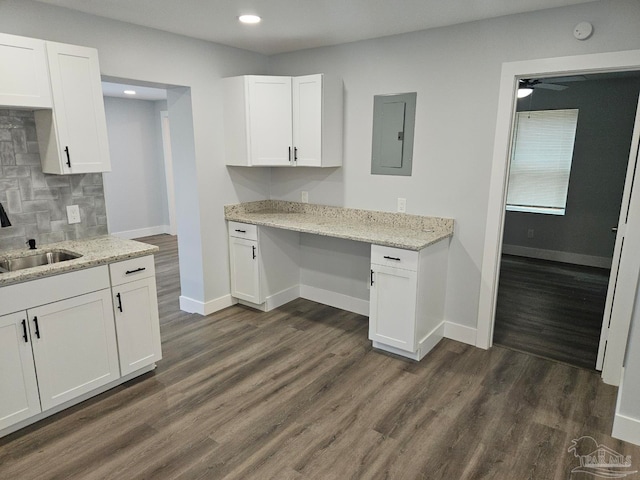 kitchen with white cabinets, sink, electric panel, dark wood-type flooring, and ceiling fan