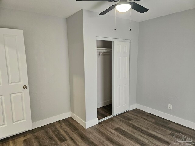 unfurnished bedroom with a closet, wood-type flooring, and ceiling fan