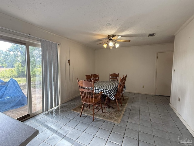 5325 Bob Sikes Blvd, Jay, FL 32565 - dining room with light tile patterned flooring, ornamental molding, a ceiling fan, a textured ceiling, and baseboards