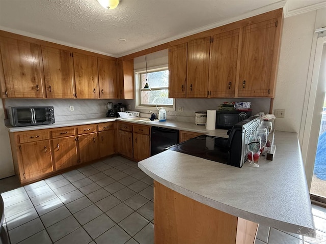 5325 Bob Sikes Blvd, Jay, FL 32565 - kitchen with brown cabinets, light countertops, a peninsula, and a textured ceiling