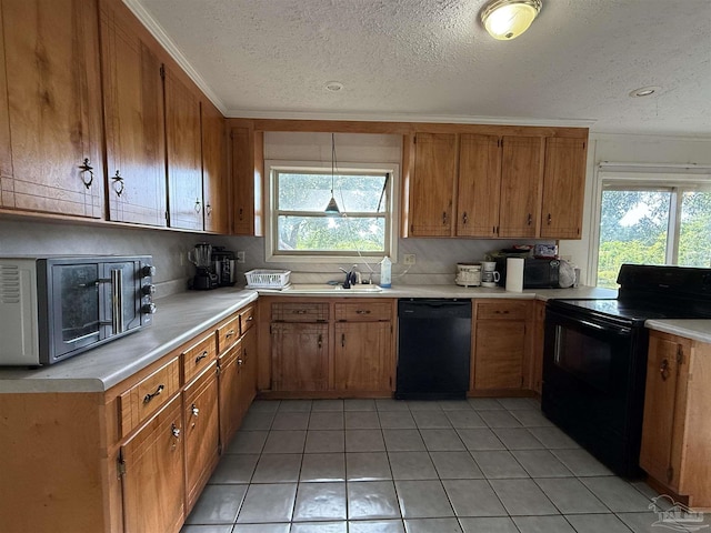 5325 Bob Sikes Blvd, Jay, FL 32565 - kitchen featuring black appliances, light countertops, light tile patterned floors, a textured ceiling, and brown cabinets
