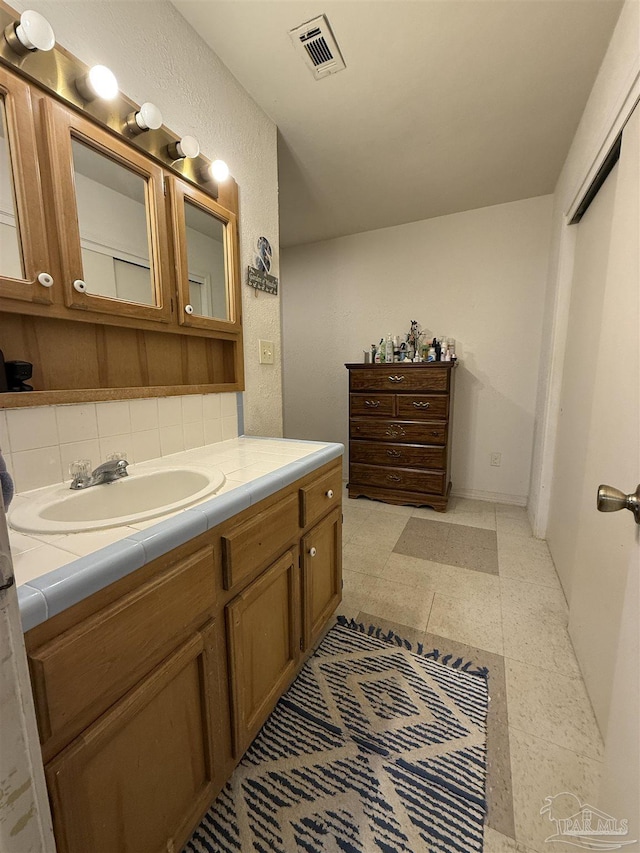 5325 Bob Sikes Blvd, Jay, FL 32565 - bathroom with vanity, decorative backsplash, and tile patterned floors