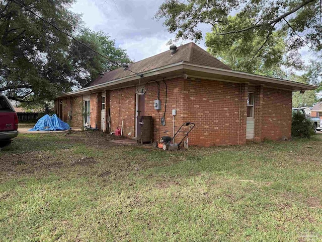 5325 Bob Sikes Blvd, Jay, FL 32565 - view of home's exterior featuring brick siding and a lawn