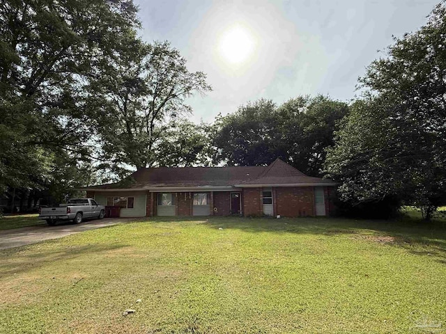 5325 Bob Sikes Blvd, Jay, FL 32565 - ranch-style house featuring a front lawn, concrete driveway, and brick siding