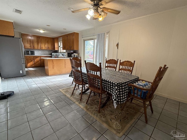 5325 Bob Sikes Blvd, Jay, FL 32565 - dining room featuring light tile patterned floors, a textured ceiling, ornamental molding, and a ceiling fan
