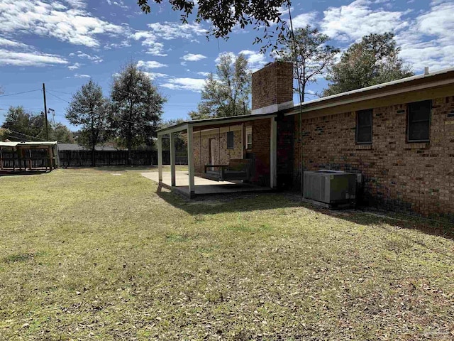 view of yard with a patio and central air condition unit