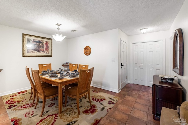 dining space featuring a textured ceiling