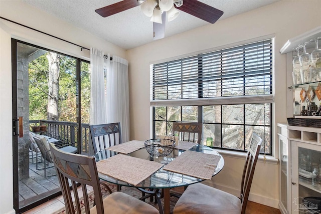 dining area featuring a textured ceiling and ceiling fan