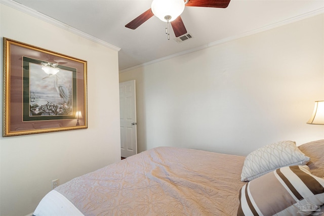 bedroom with ceiling fan and ornamental molding