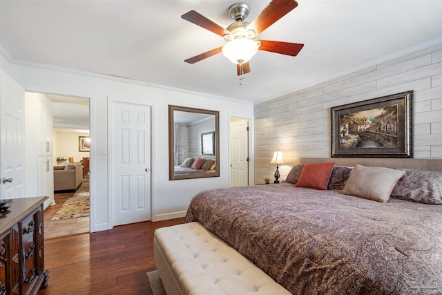 bedroom with dark hardwood / wood-style flooring, ceiling fan, and ornamental molding