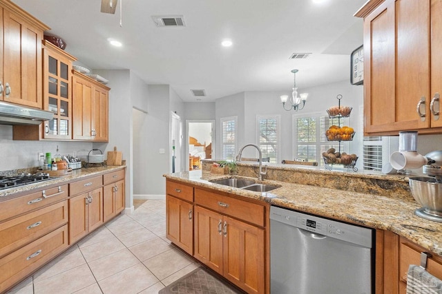 kitchen featuring light stone counters, stainless steel appliances, sink, light tile patterned floors, and pendant lighting