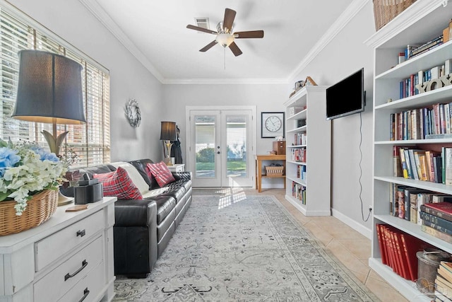 living area with french doors, ceiling fan, ornamental molding, and light tile patterned flooring