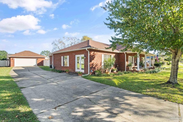 ranch-style house with a front lawn, a porch, a garage, and french doors