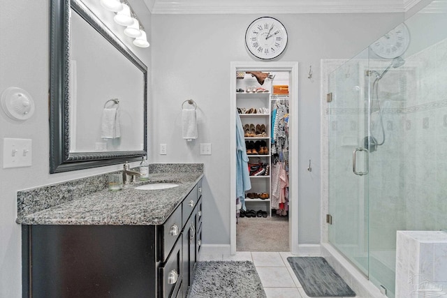 bathroom featuring tile patterned floors, walk in shower, vanity, and ornamental molding