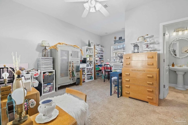 bedroom featuring carpet, ensuite bath, ceiling fan, and sink