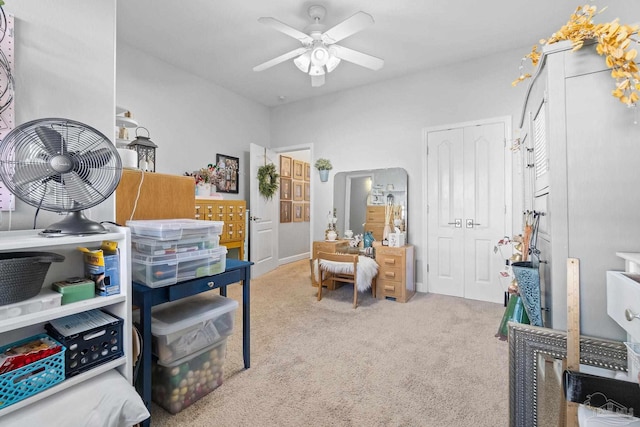 interior space with ceiling fan and light colored carpet