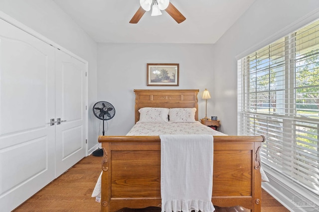 bedroom featuring light wood-type flooring, a closet, and ceiling fan