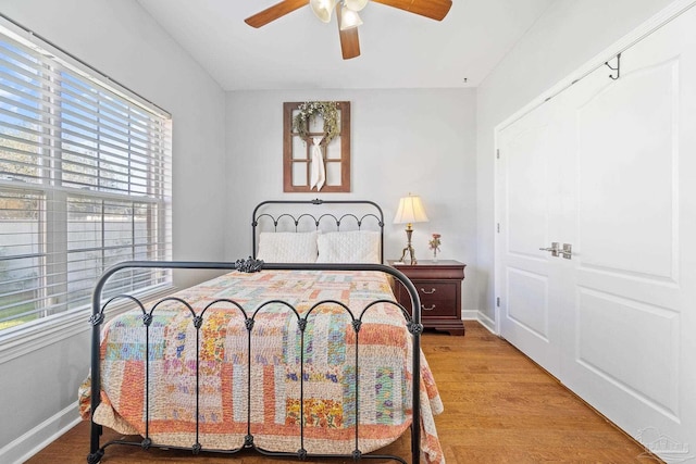 bedroom with hardwood / wood-style flooring and ceiling fan