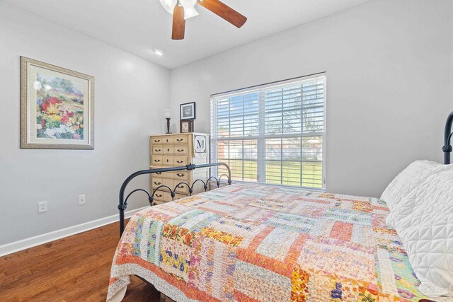 bedroom with hardwood / wood-style floors and ceiling fan