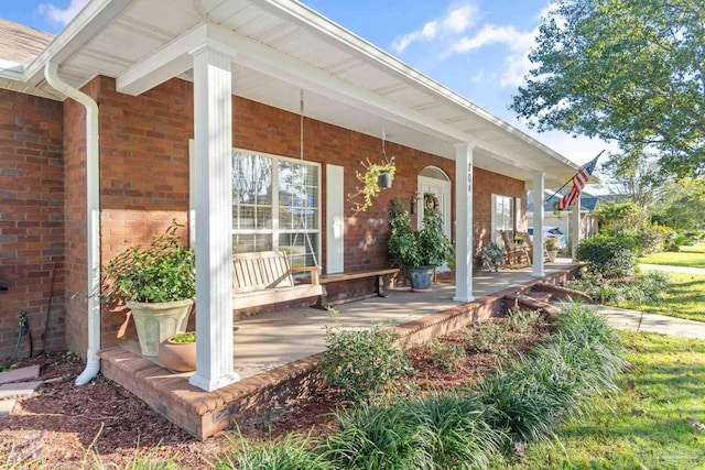 view of exterior entry featuring covered porch